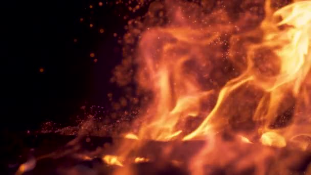 SLOW MOTION: Sparkles flying out of a orange campfire burning in the darkness. — Stock Video