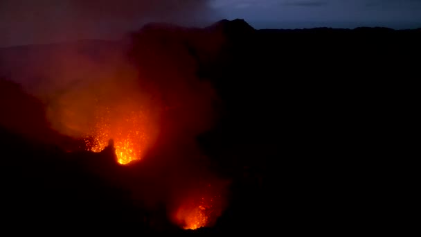 Hot orange magma is exploding out of the active crater and high into the air. — Stock Video