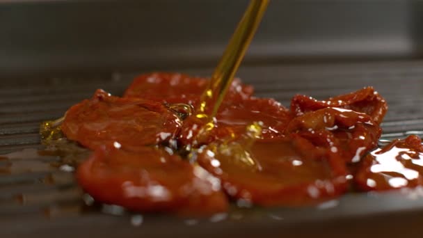 SLOW MOTION: Organic olive oil splashes over the homegrown sundried tomatoes. — Stock Video