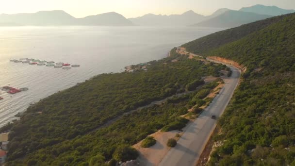 AERIAL: Beautiful shot of Mediterranean nature and sea surrounding car cruising. — 图库视频影像