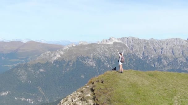 AERIAL: Young woman hiking in the Dolomites celebration ates reaching the Summit. — 图库视频影像