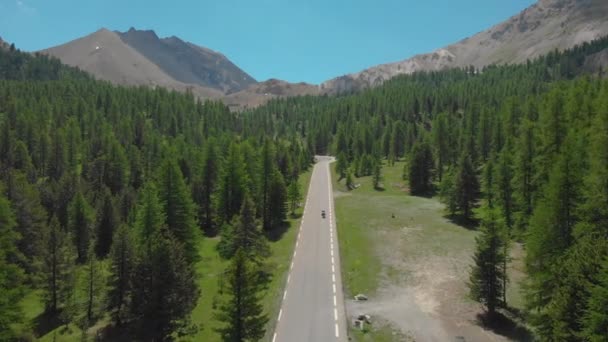 DRONE: Motorcycle riders cruising along a scenic road in French countryside. — Stock Video