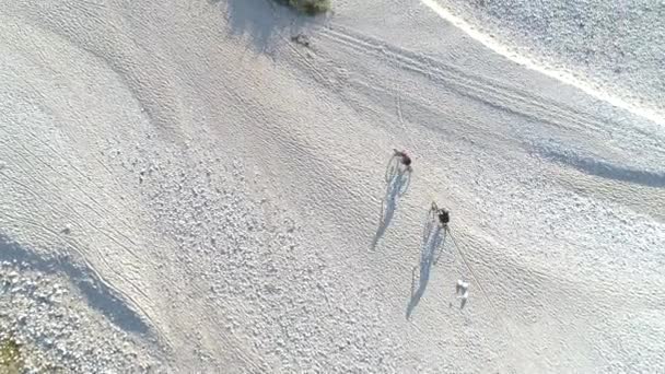 TOP DOWN: Δύο μη αναγνωρίσιμοι τουρίστες που οδηγούν ποδήλατα βουνού κατά μήκος βραχώδους εδάφους. — Αρχείο Βίντεο