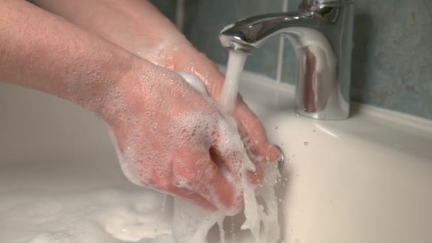 CLOSE UP: Unrecognizable woman rinses her soapy hands after a trip to bathroom. — Stock Video