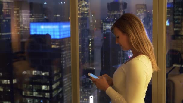 CERRAR: Chica escribiendo un texto tarde en la noche mientras aún está en su oficina en Nueva York — Vídeos de Stock