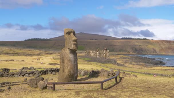 AERIAL: Voando em torno de uma grande escultura moai em uma ilha remota no ensolarado Chile . — Vídeo de Stock