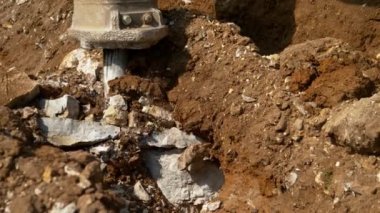 Kaya matkabı kayaları eziyor ve inşaat alanında toprak taşıyor..