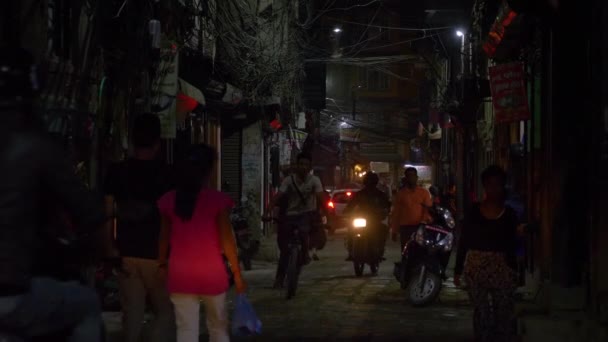 CLOSE UP: Motorbikers and cars drive up and down a busy street in Kathmandu. — Stock Video