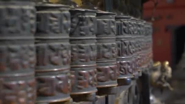 CLOSE UP: Cinematic shot van metalen gebedswielen draaien in een hindoe tempel. — Stockvideo