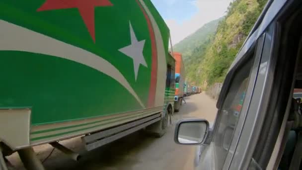 POV: Driving along a long queue of cargo trucks waiting to cross the border — Stock Video