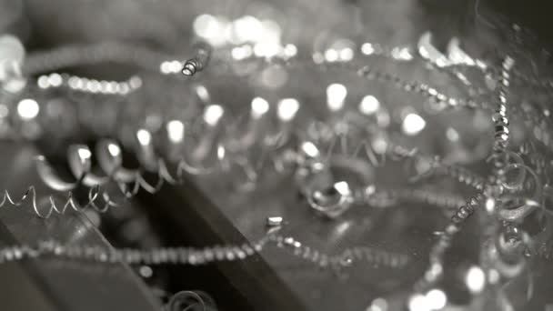 BOKEH: Curly metal chippings lay scattered around CNC machine after end milling. — Stock Video