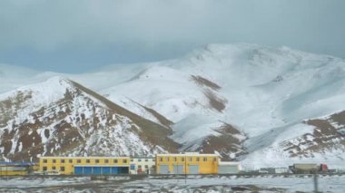 Yük kamyonları Çin kırsalındaki küçük bir köyden geçiyor.