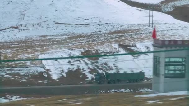 SLOW MOTION: Shot from a moving train of a freight truck driving down empty road — Stock Video