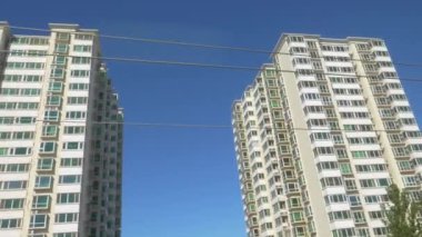 Güneşli bir günde Pekin sokaklarının üstündeki apartman kulesi..