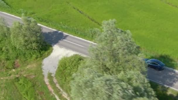 DRONE Moderne zelfsturende auto rijdt langs de levendige groene weiden in Slovenië — Stockvideo