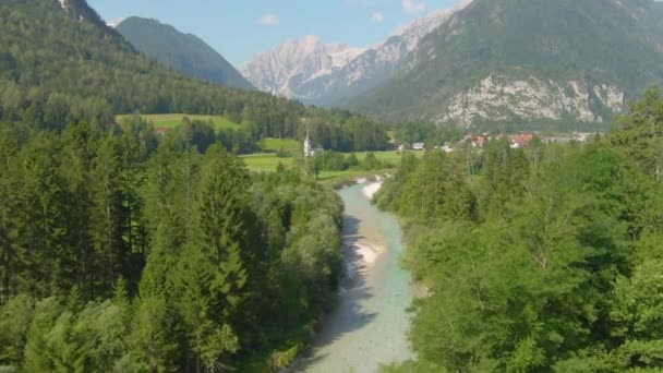 AERIAL: Flying above a turquoise mountain stream running through the countryside — Stock Video