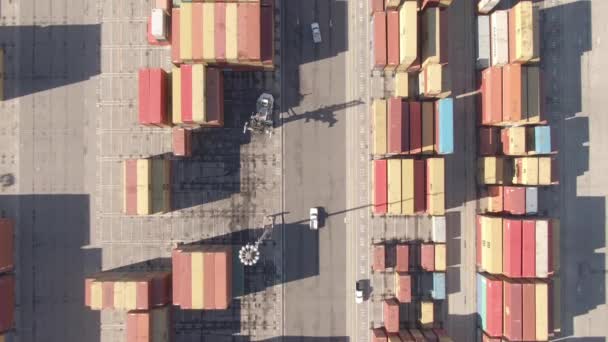 AERIAL: Flying along street running past freight containers in industrial harbour — 图库视频影像