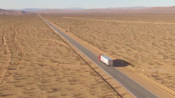 DRONE: Tehergépkocsi halad végig az autópályán, ami átvezet a Mojave sivatagon. — Stock videók