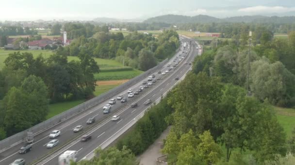 DRONE: Flying along long traffic jam formed on highway crossing the countryside — Stock Video