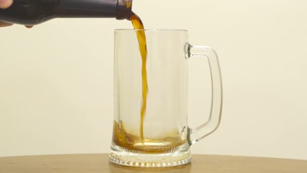 Pouring Beer Into A Glass On White Background. Slow Motion — ストック動画