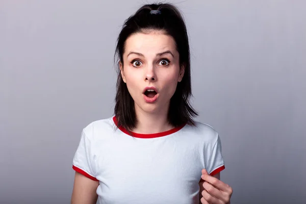 Atractiva Chica Emocional Una Camiseta Roja Blanca Sobre Fondo Gris —  Fotos de Stock