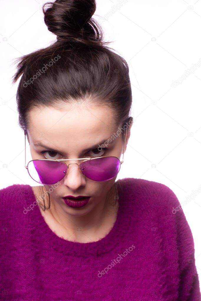 girl in a purple sweater, purple glasses with purple lipstick on her lips