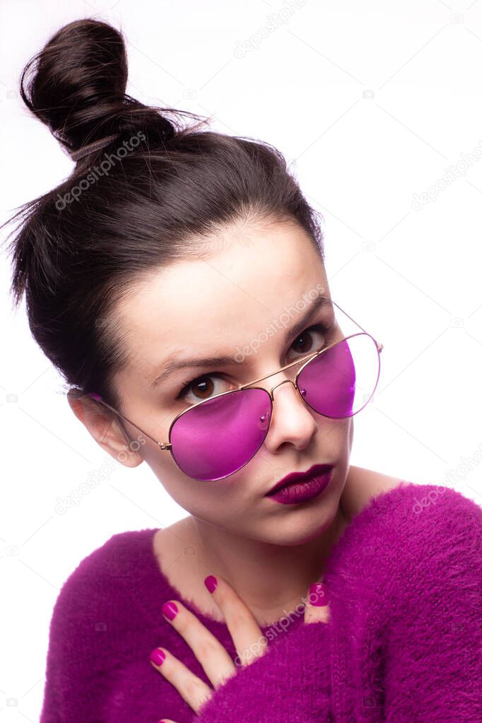 girl in a purple sweater, purple glasses with purple lipstick on her lips