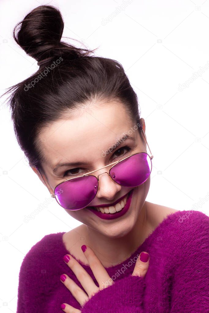 girl in a purple sweater, purple glasses with purple lipstick on her lips