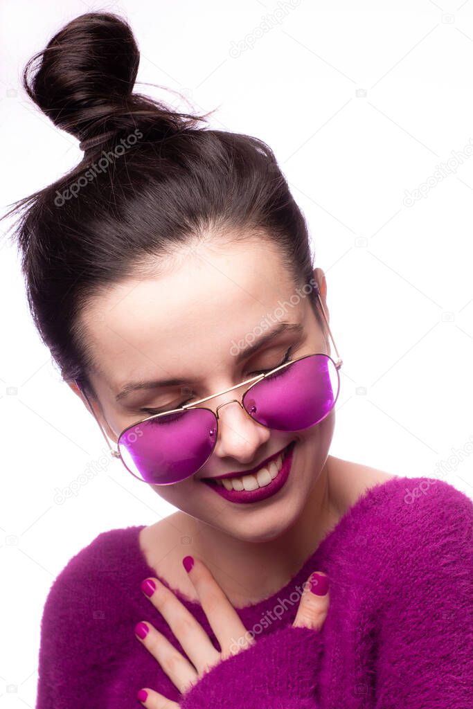 girl in a purple sweater, purple glasses with purple lipstick on her lips