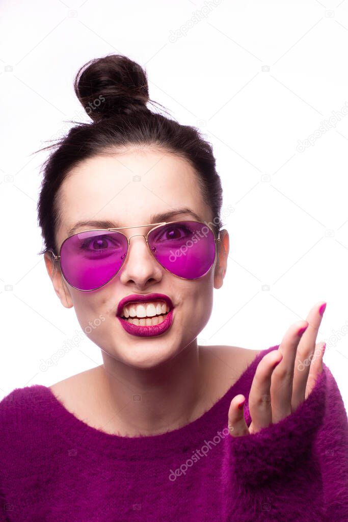 girl in a purple sweater, purple glasses with purple lipstick on her lips