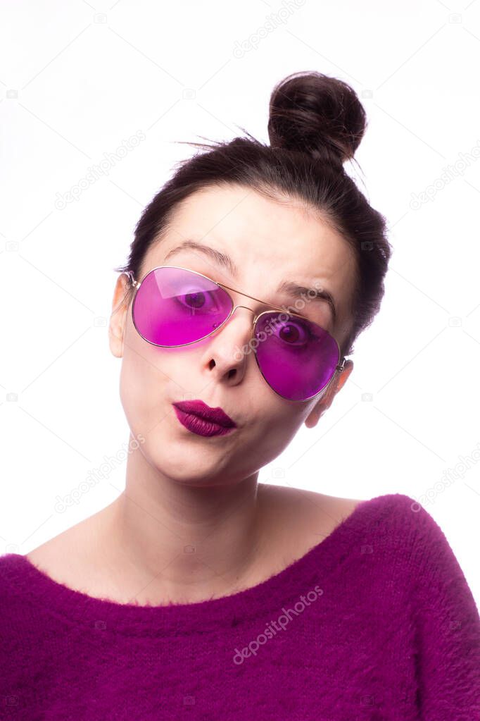 girl in a purple sweater, purple glasses with purple lipstick on her lips