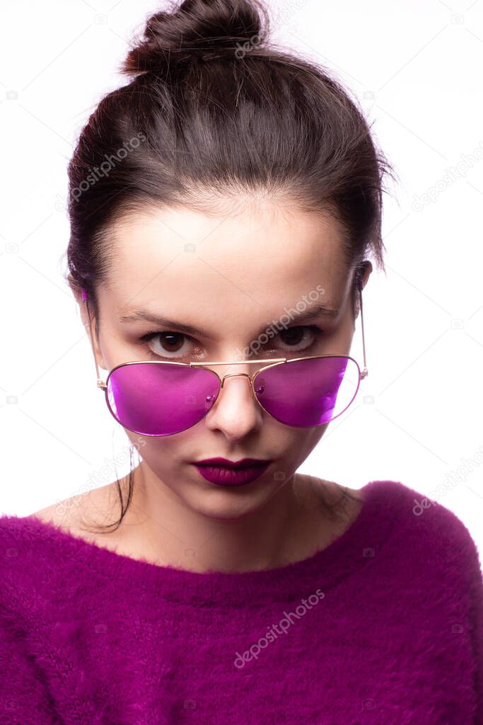 girl in a purple sweater, purple glasses with purple lipstick on her lips