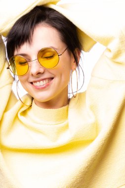 Sarı gözlüklü ve sarı kazaklı güzel kız.