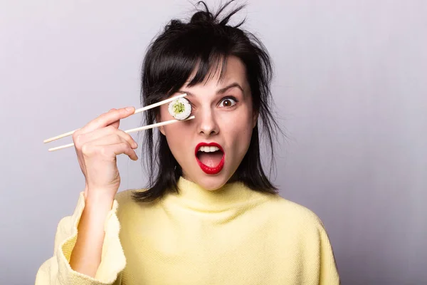 Mulher Engraçada Com Uma Camisola Amarela Comer Sushi Sushi Paus — Fotografia de Stock