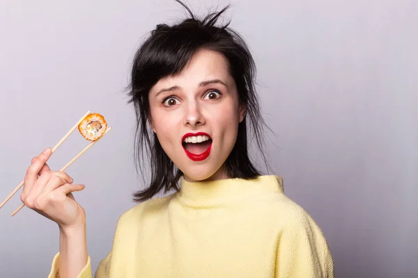 Woman holds chopsticks sushi rolls Japan Asia