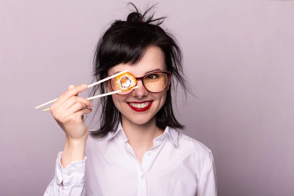 beautiful girl student holds chopsticks sushi rolls Japan Asia