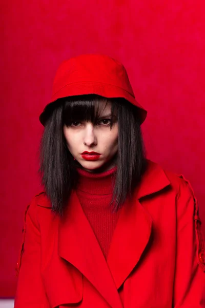 bright woman in red clothes on a red background