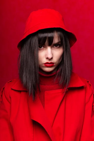 woman with bangs in red clothes, red background