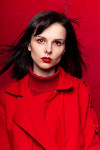 girl in red clothes, red background, red lips, the wind in her hair