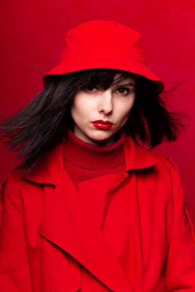 girl in red clothes, red background, red lips, the wind in her hair
