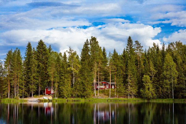 Red wooden cottage by the lake