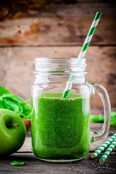 healthy green smoothie with green apples, spinach and chia seeds in mason jar