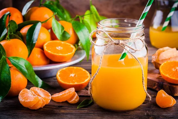 Jugo de naranja orgánico en un frasco de albañil de vidrio — Foto de Stock
