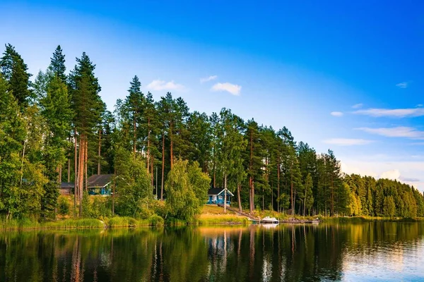 Голубой деревянный бревенчатый домик на озере в Финляндии — стоковое фото