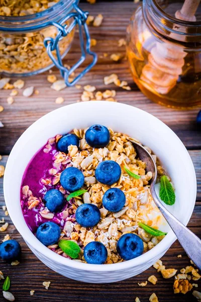 Yoghurt med müsli och blåbär sås, färska blåbär och mynta — Stockfoto