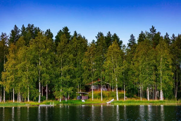 Houten blokhut aan het meer in de zomer in Finland — Stockfoto