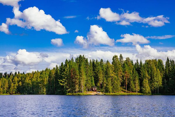 Wooden sauna log cabin at the lake in summer in Finland