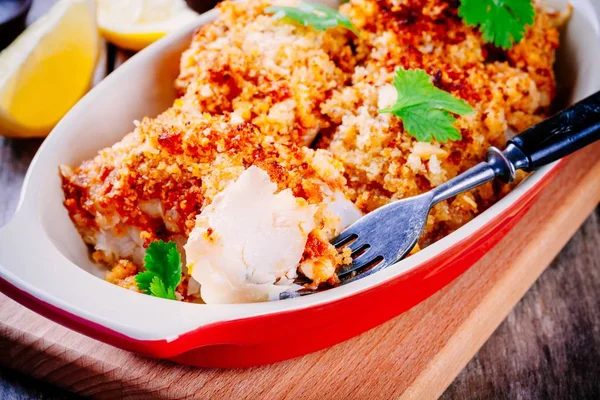 Baked codfish in breadcrumbs in gratin dish closeup — Stock Photo, Image