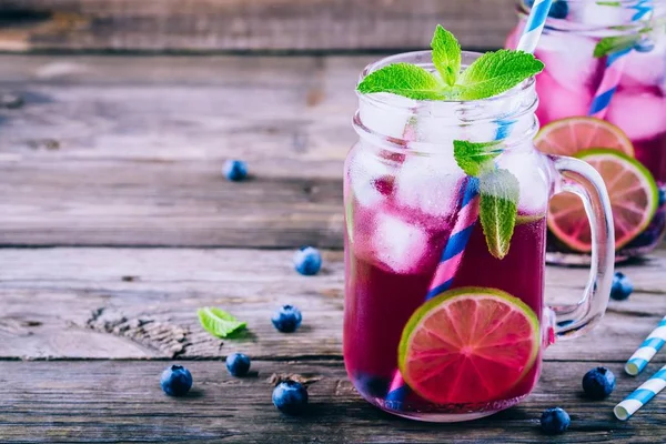 Blueberry ice mojito with lime and mint in mason jar — Stock Photo, Image