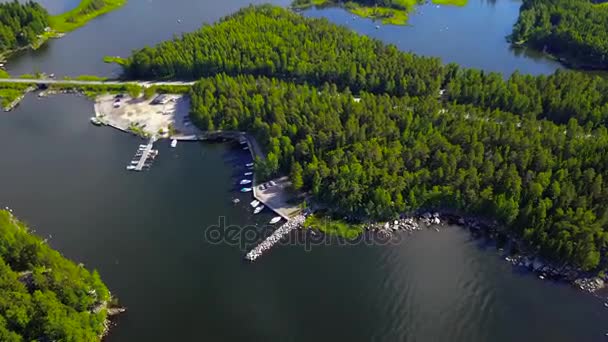 A small marina with a parking and a bridge on the forest islands of the archipelago in the bay. — Stock Video